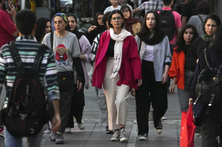 Iran's parliament passes a stricter headscarf law days after protest anniversary