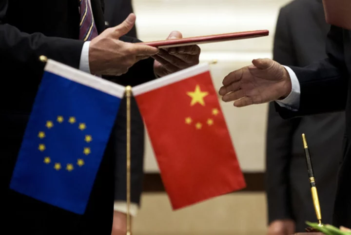 EU commissioner, in China, calls for more balanced trade and warns that Ukraine could divide them